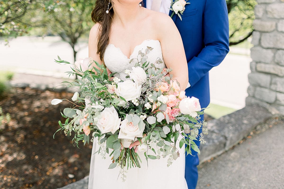 Arielle Peters Photography | Bride and groom in each other's arms outside at The Bridgewater Club in Carmel, Indiana on wedding day.