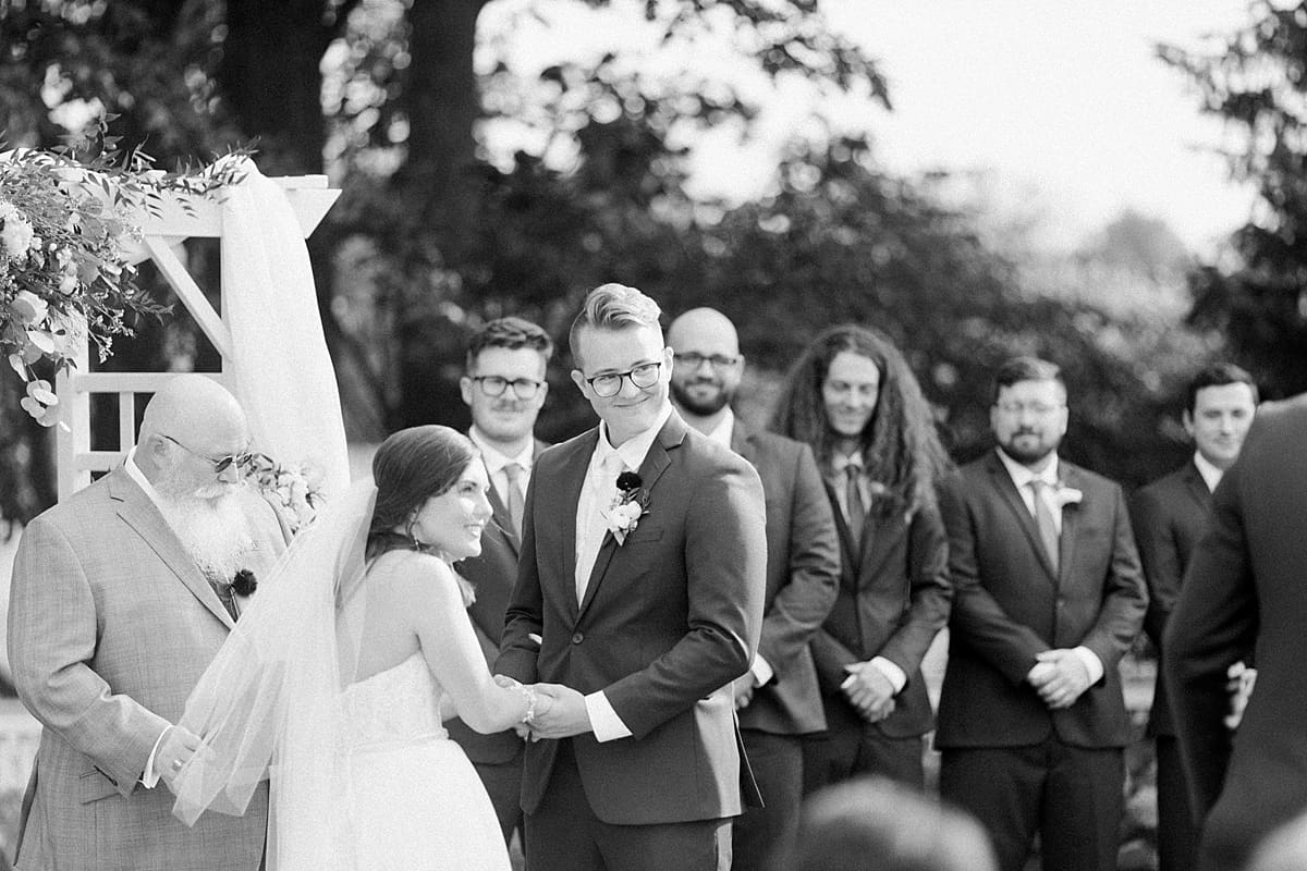 Arielle Peters Photography | Bride and groom holding hands at the alter at The Bridgewater Club in Carmel, Indiana on wedding day.