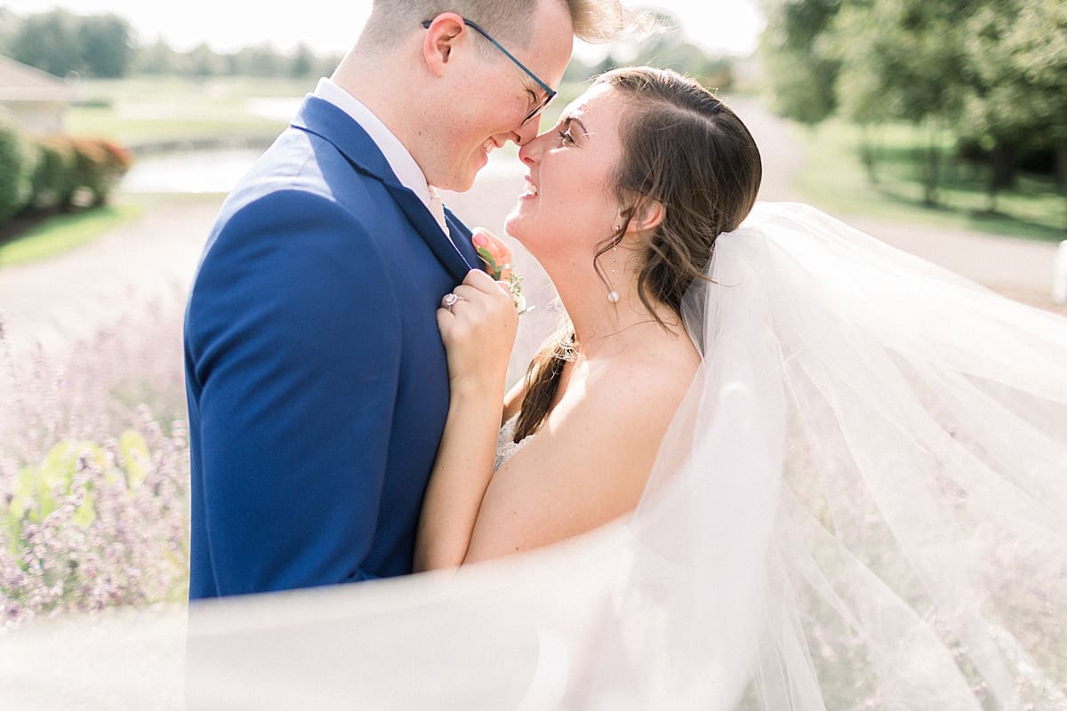 Arielle Peters Photography | Bride and groom smiling in a field at The Bridgewater Club in Carmel, Indiana on wedding day.