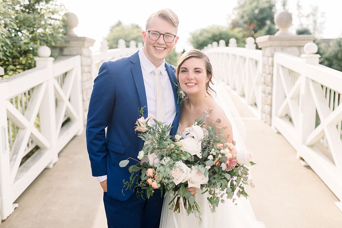 Arielle Peters Photography | Bride and groom smiling on a bridge at The Bridgewater Club in Carmel, Indiana on wedding day.