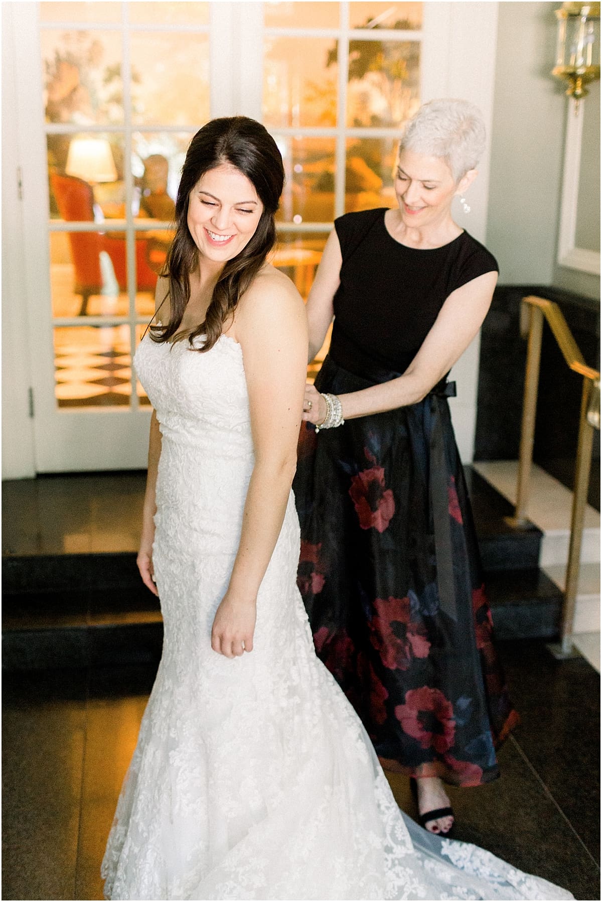 Arielle Peters Photography | Mother of the bride helping the bride put on her dress on wedding day in Madison, Wisconsin.