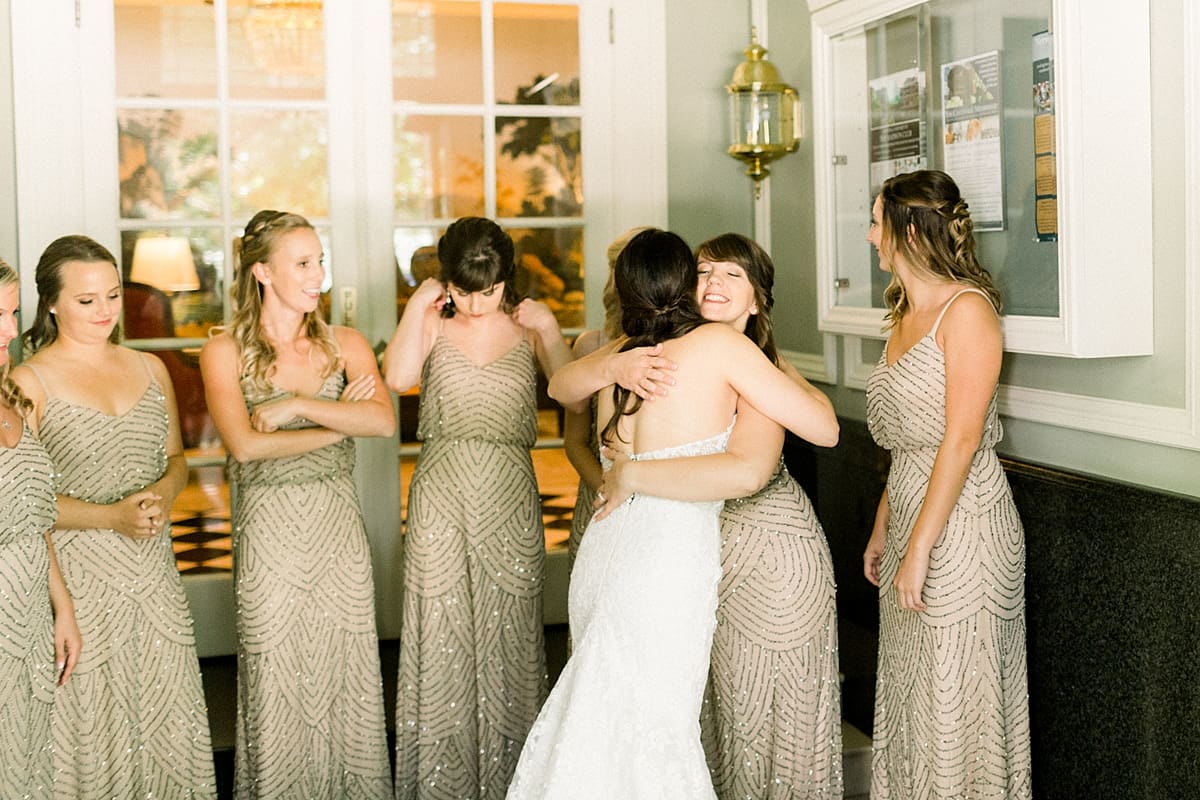 Arielle Peters Photography | Bridesmaids hugging bride on wedding day in Madison, Wisconsin.