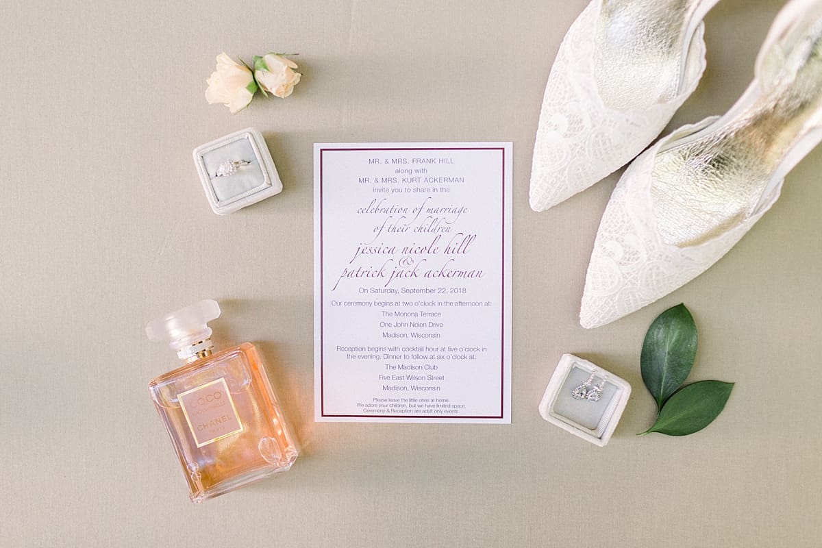 Arielle Peters Photography | Wedding invitation and bride's perfume in a flat-lay on wedding day in Madison, Wisconsin.