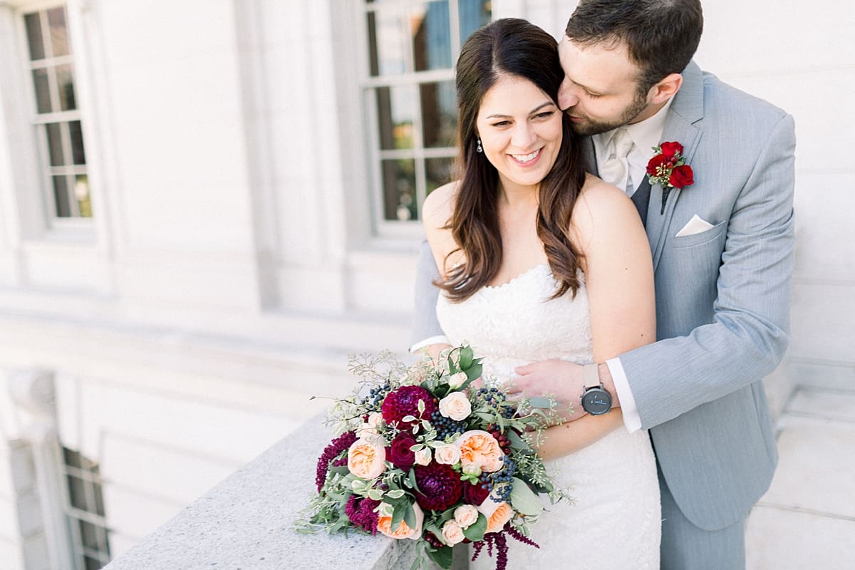 Arielle Peters Photography | Groom kissing the bride on wedding day outside downtown Madison, Wisconsin.