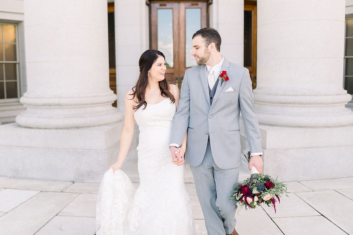 Arielle Peters Photography | Bride and groom smiling at each other outside downtown Madison, Wisconsin on wedding day.