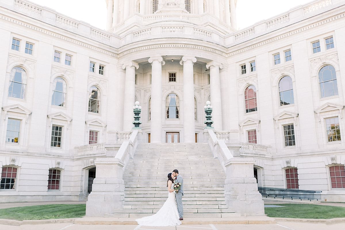 Arielle Peters Photography | Bride and groom kissing on steps outside Monona Terrrace in Madison, Wisconsin on wedding day.