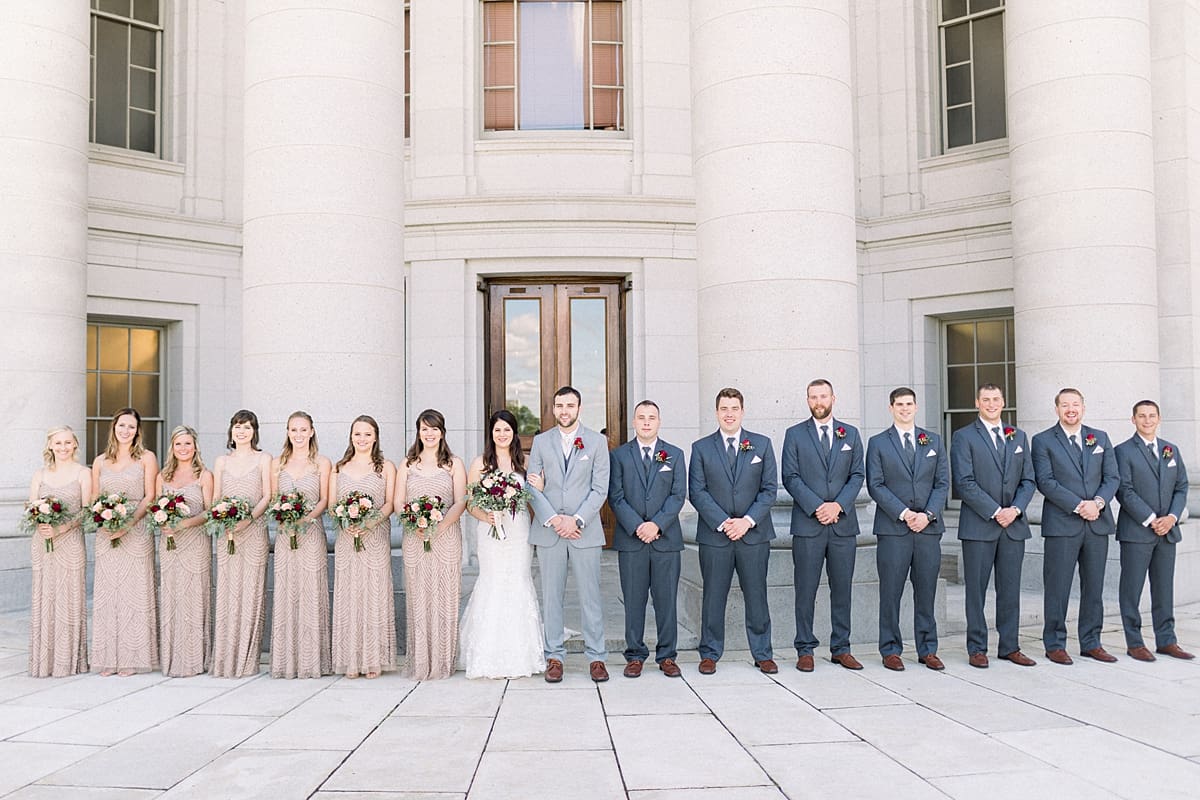 Arielle Peters Photography | Bride and groom lined up with wedding party outside Monona Terrace in Madison, Wisconsin on wedding day.