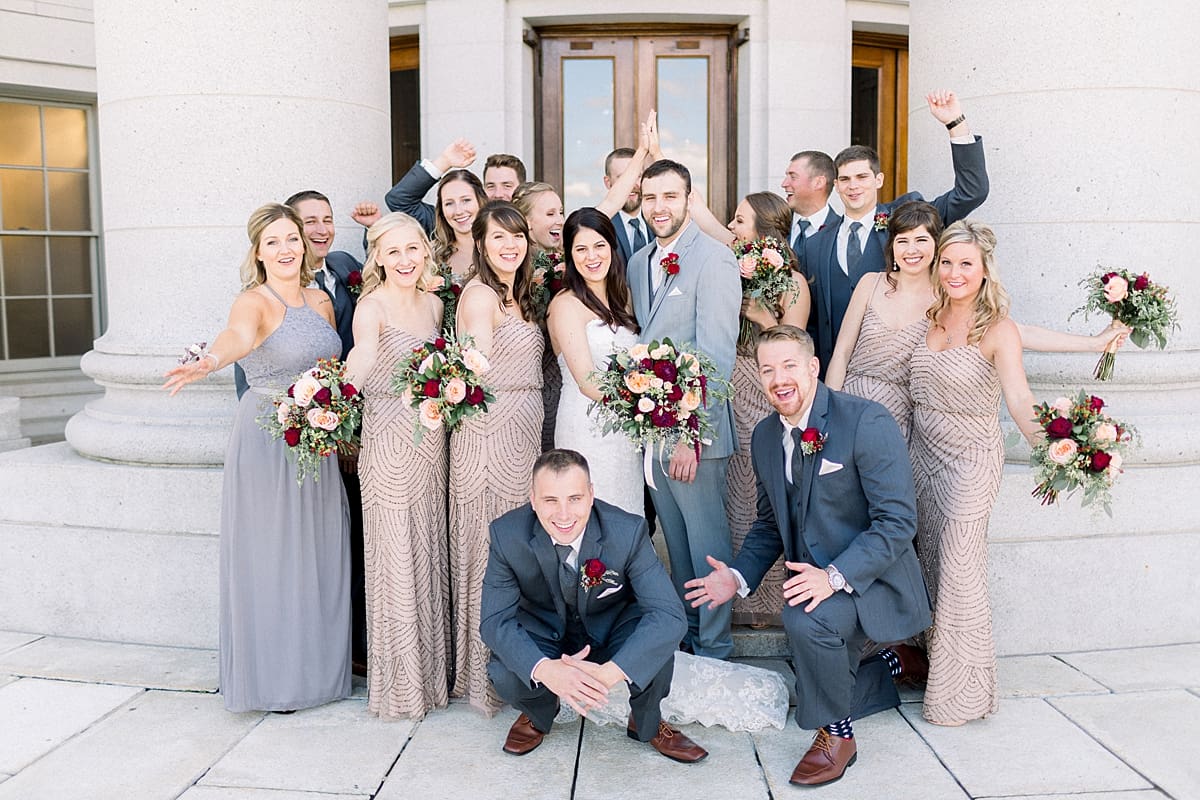 Arielle Peters Photography | Wedding party cheering around bride and groom on wedding day in downtown Madison, Wisconsin.