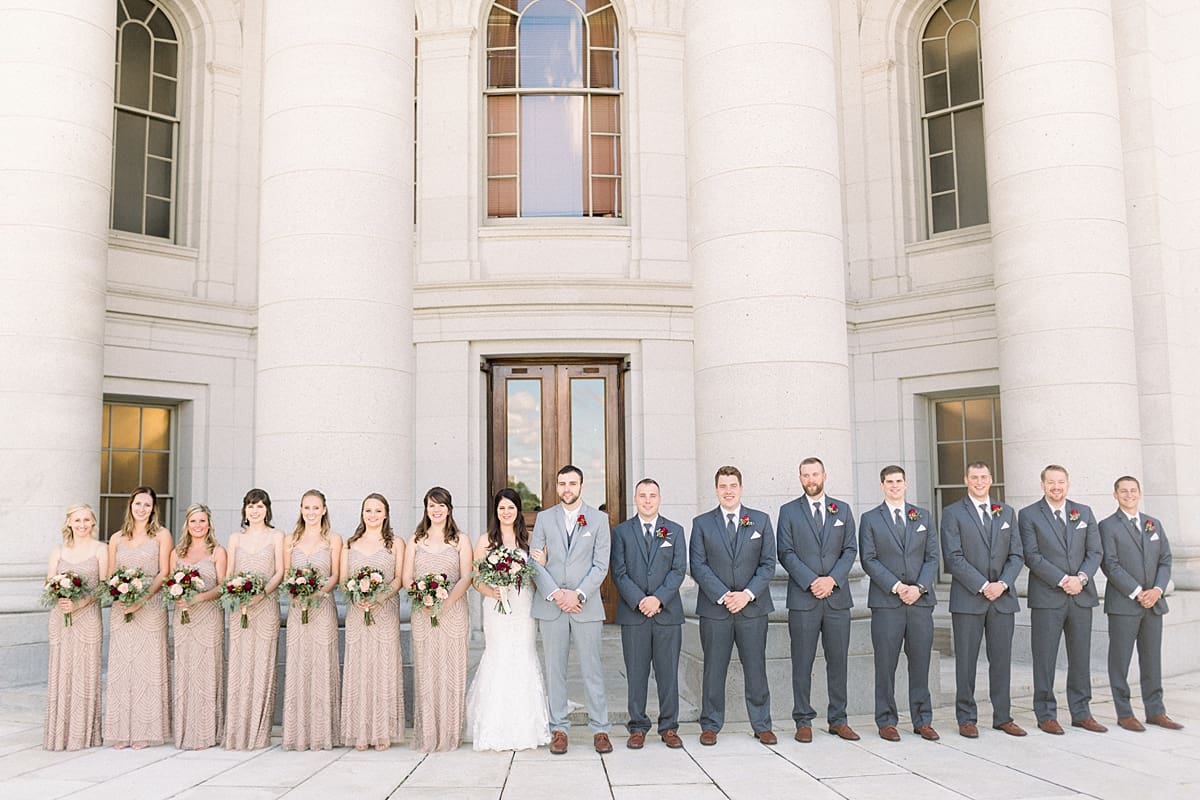 Arielle Peters Photography | Bride and groom lined up with wedding party outside Monona Terrace in Madison, Wisconsin on wedding day.