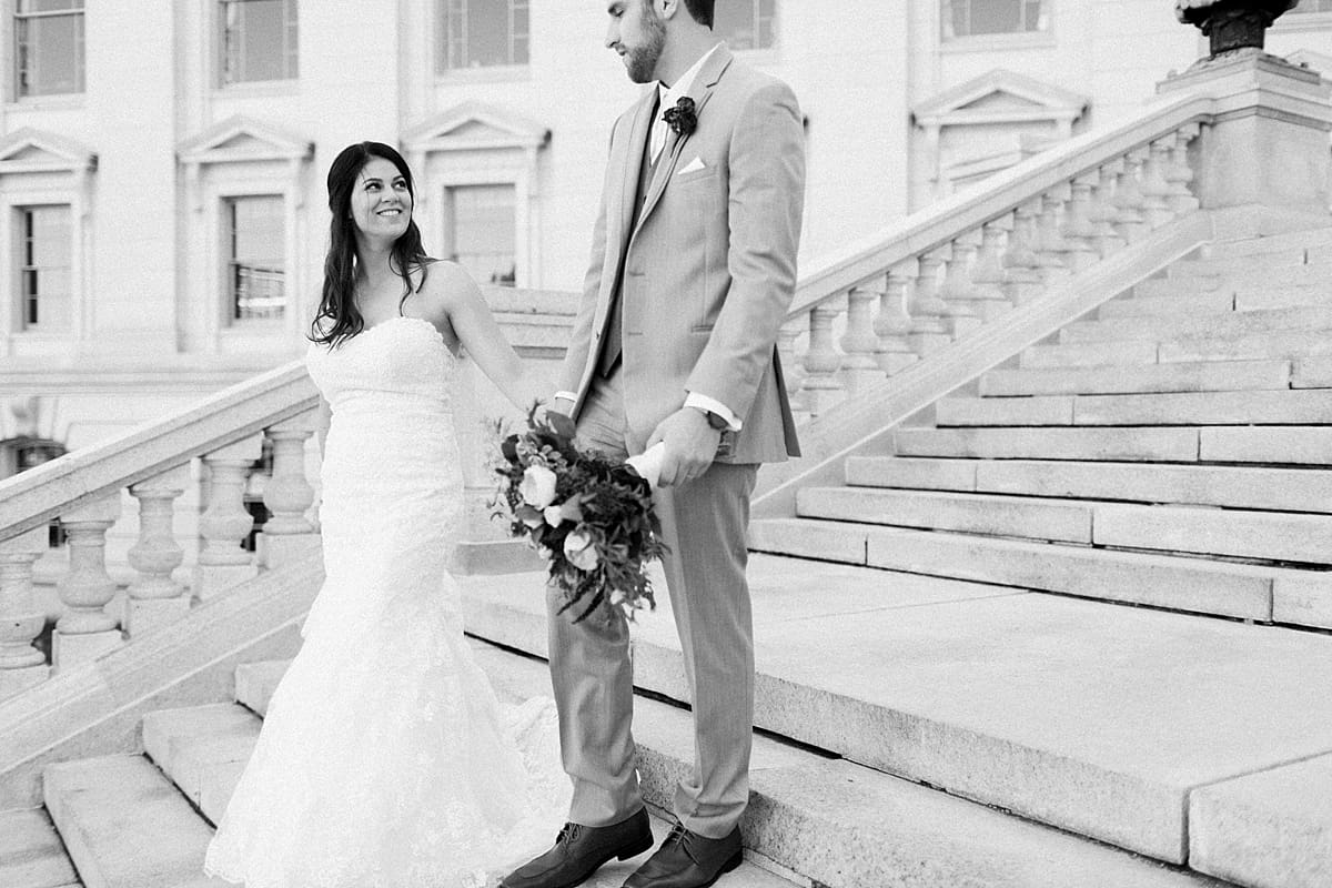 Arielle Peters Photography | Bride and groom walking down stairs at Monona Terrace in Madison, Wisconsin on wedding day.