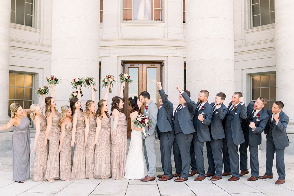 Arielle Peters Photography | Bride and groom kissing and wedding party kissing on wedding day in Madison, Wisconsin.