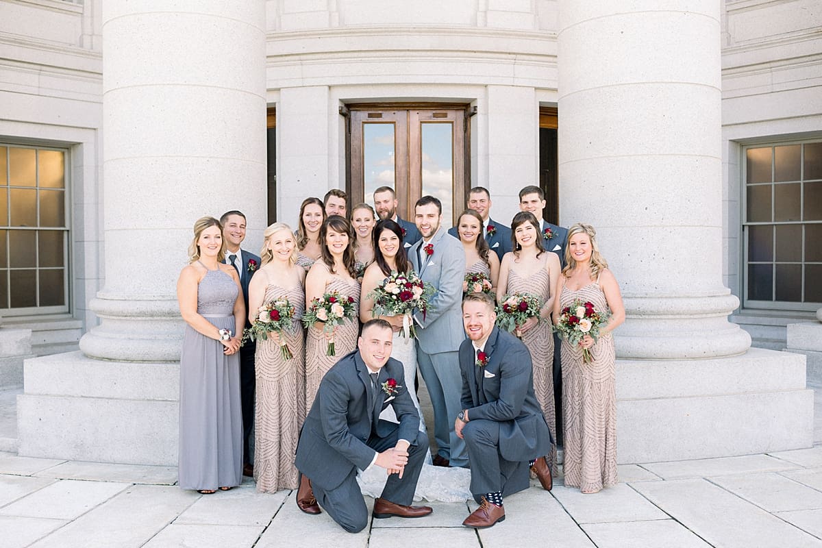 Arielle Peters Photography | Bride and groom smiling with wedding party outside Monona Terrace in Madison, Wisconsin on wedding day.