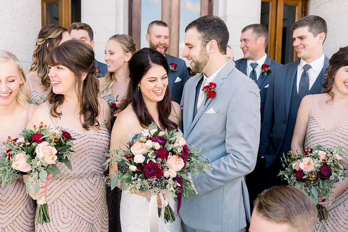 Arielle Peters Photography |  Bride and groom laughing with wedding party outside Monona Terrace in Madison, Wisconsin.