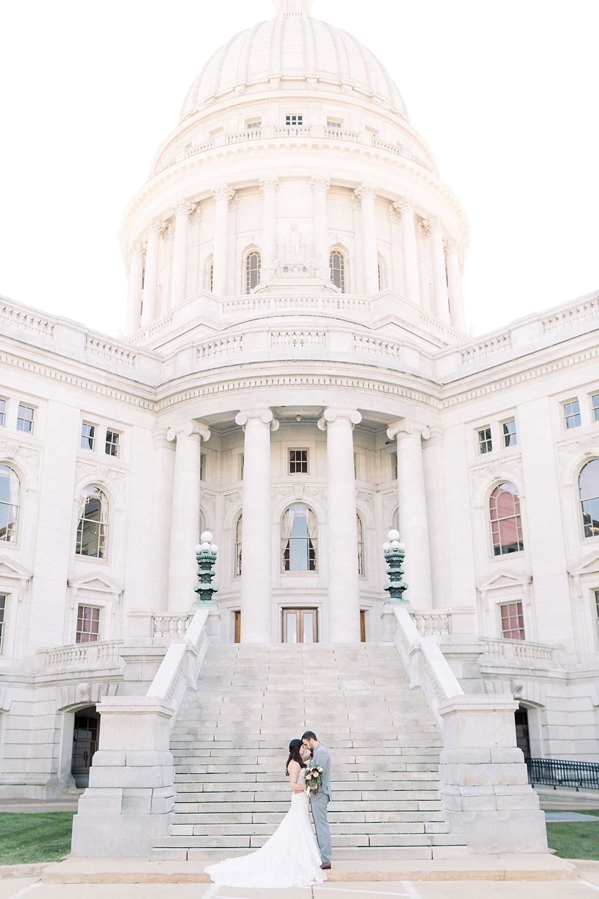 Arielle Peters Photography |  Bride and groom kissing on steps at Monona Terrace outside Madison, Wisconsin.