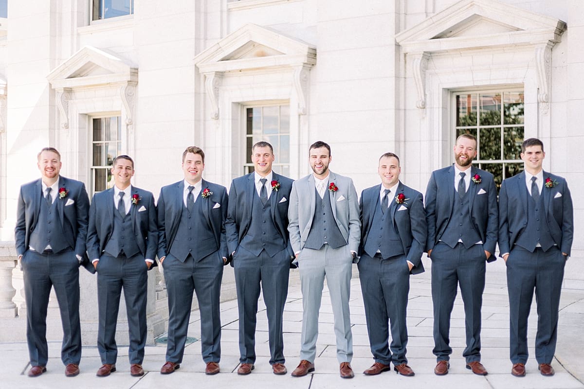 Arielle Peters Photography | Groom and groomsmen with hands in pockets outside Monona Terrace in Madison, Wisconsin on wedding day.