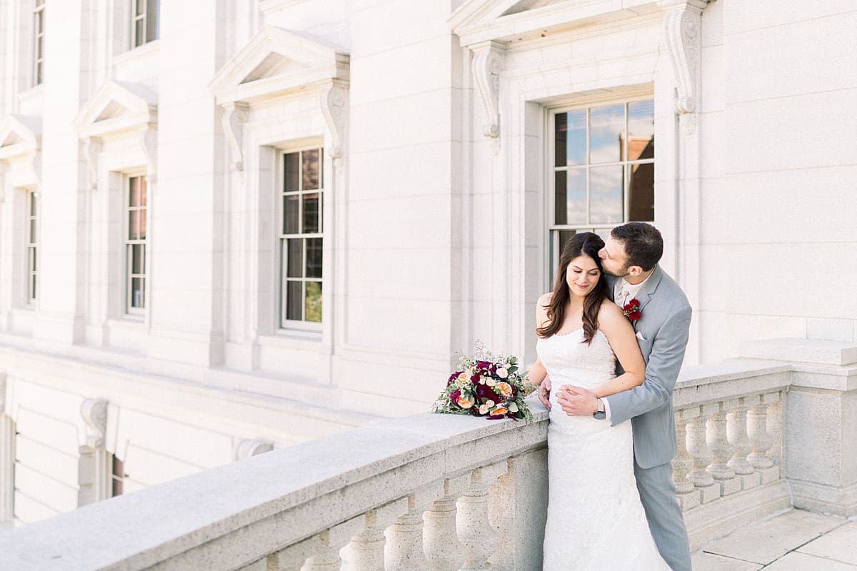 Arielle Peters Photography | Groom kissing bride's forehead outside Monona Terrace in Madison, Wisconsin on wedding day.