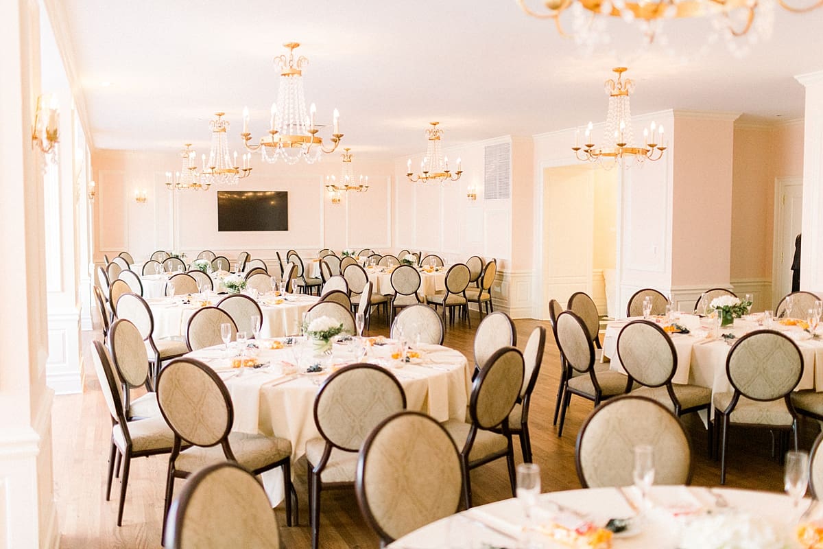 Arielle Peters Photography | Table settings and chandeliers inside the Madison Club in Madison, Wisconsin on wedding day.