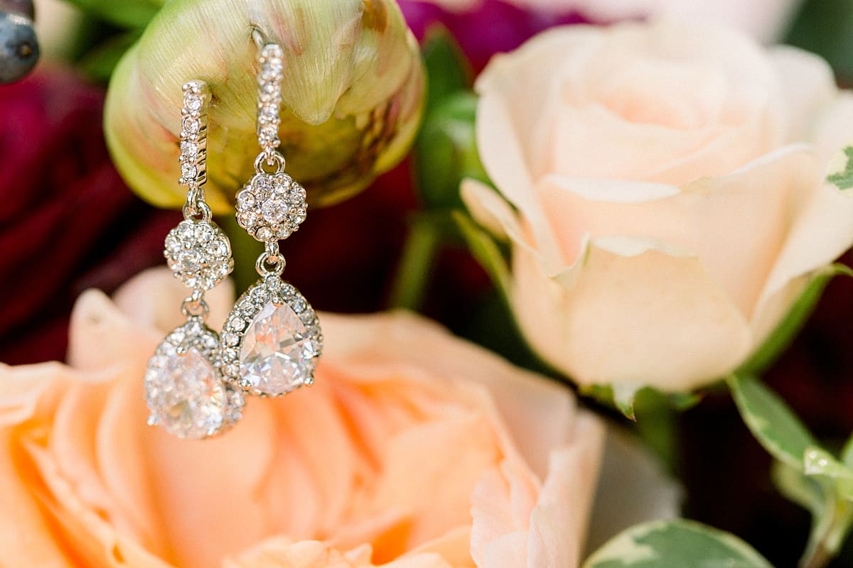 Arielle Peters Photography | Wedding day earring hanging on wedding flower bouquet on wedding day in Madison, Wisconsin.
