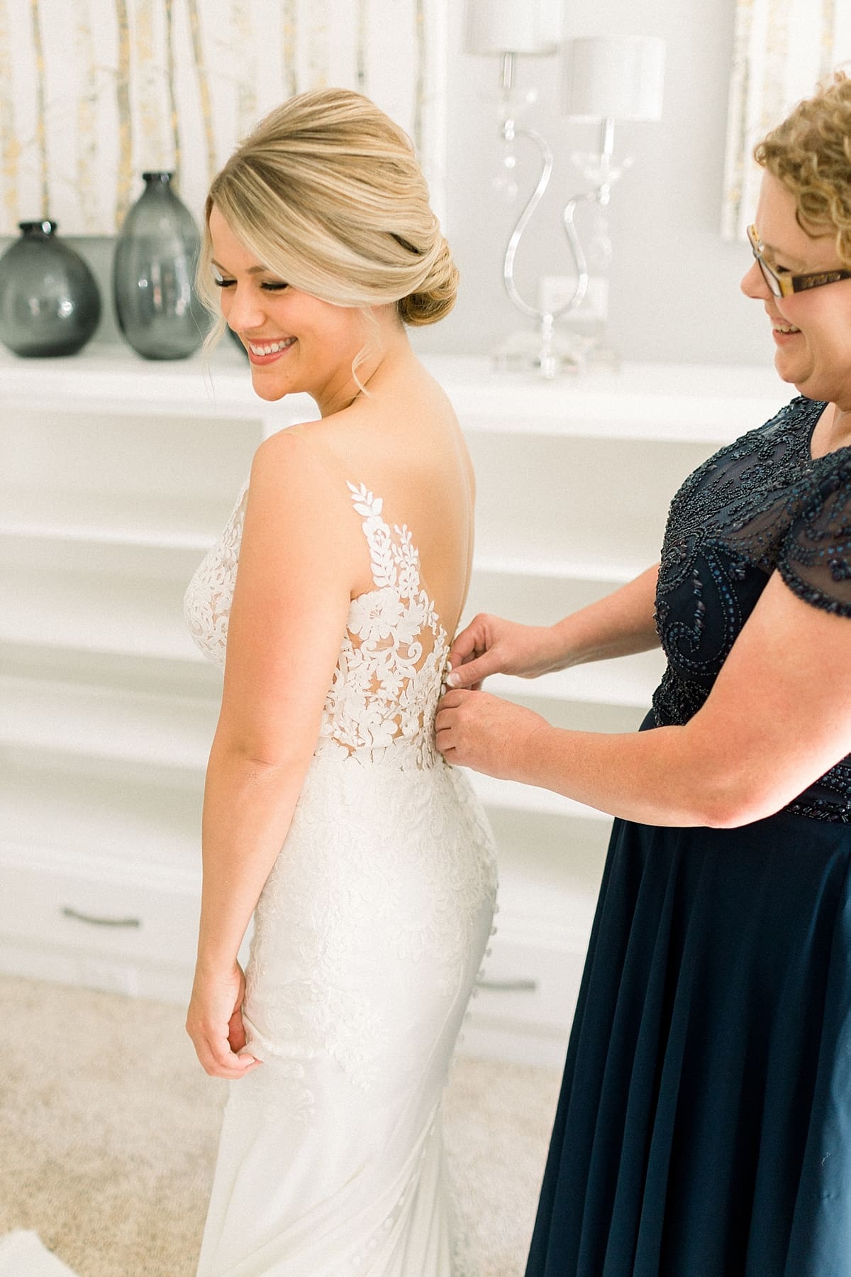 Arielle Peters Photography | Mother of the bride helping the bride put on her wedding dress at The Morris Estate in Niles, Michigan on wedding day. 