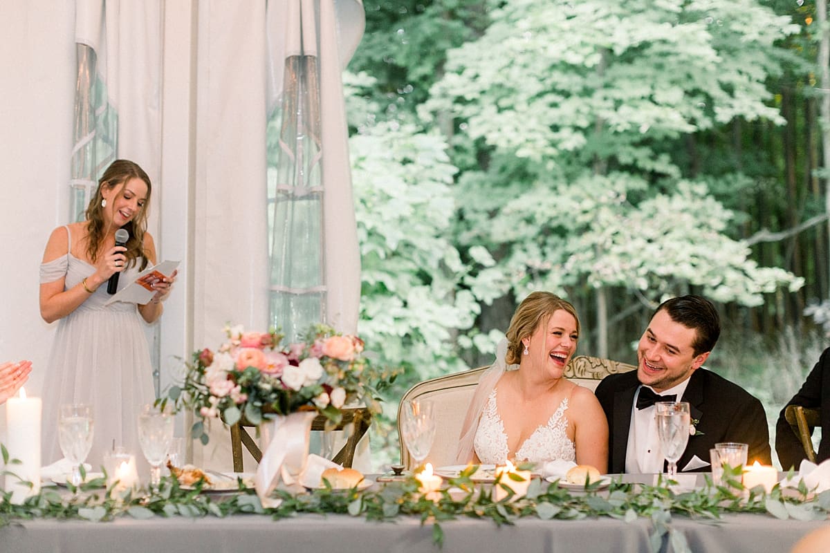 Arielle Peters Photography | Bride and groom laughing during speeches at wedding reception at The Morris Estate in Niles, Michigan on wedding day.  