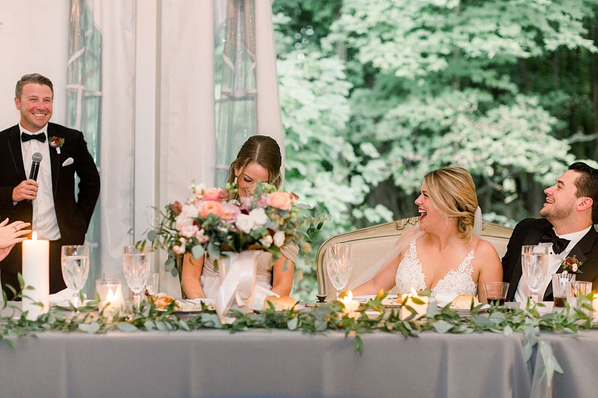 Arielle Peters Photography | Bride and groom laughing during speeches at wedding reception at The Morris Estate in Niles, Michigan on wedding day.  