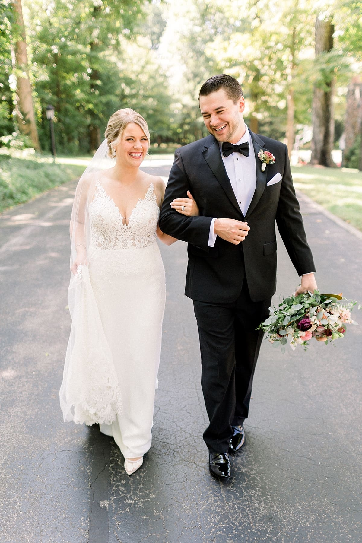 Arielle Peters Photography | Bride and groom smiling and walking on wedding day at The Morris Estate in Niles, Michigan on wedding day. 