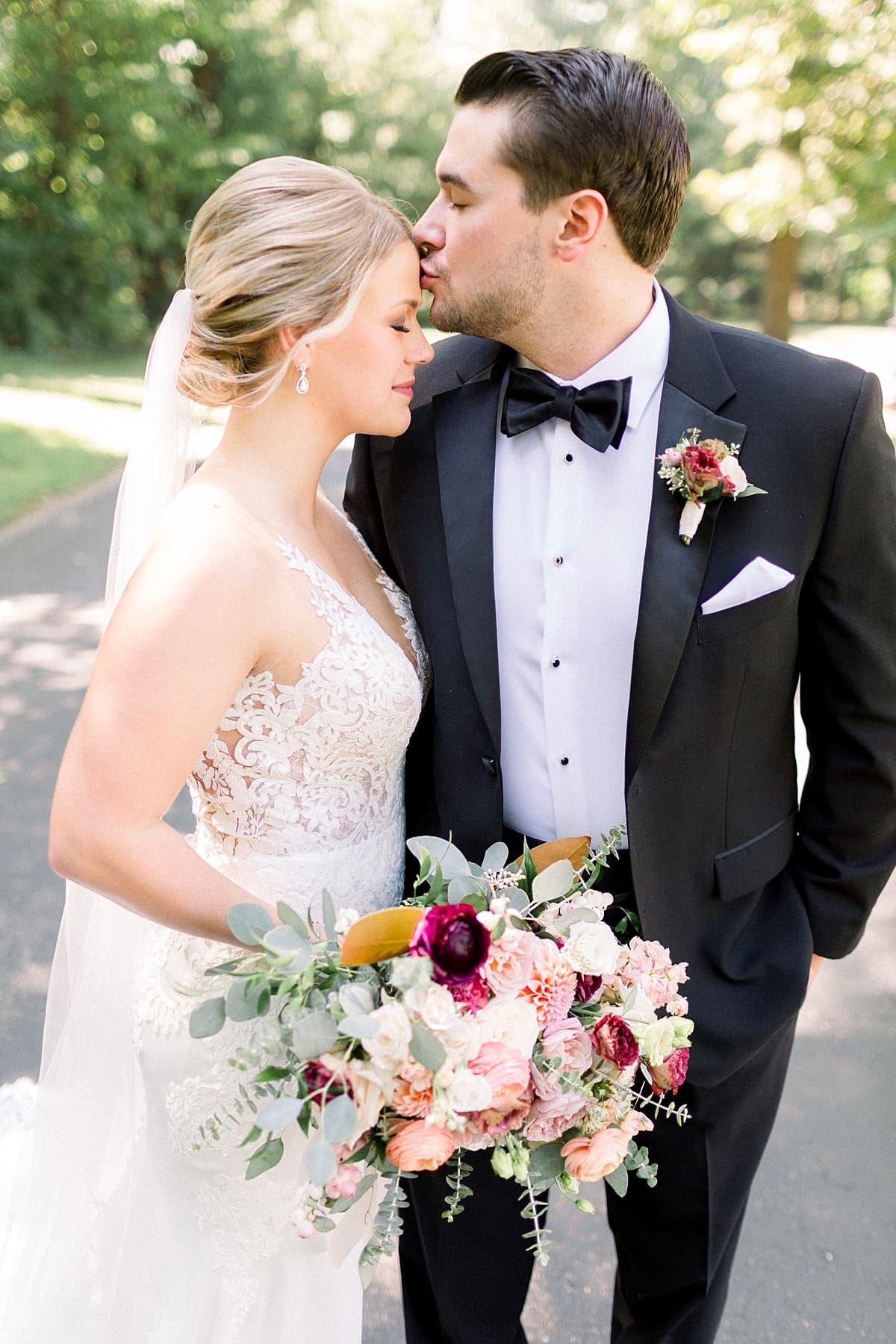 Arielle Peters Photography | Groom kissing bride on wedding day at The Morris Estate in Niles, Michigan on wedding day. 