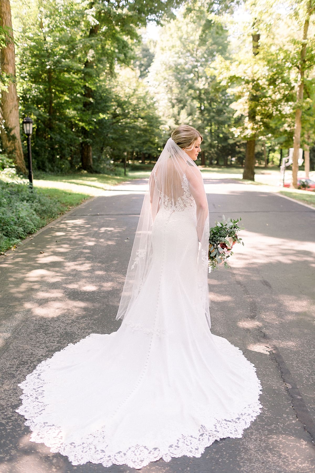 Arielle Peters Photography | Bride standing in the street on wedding day at The Morris Estate in Niles, Michigan on wedding day. 