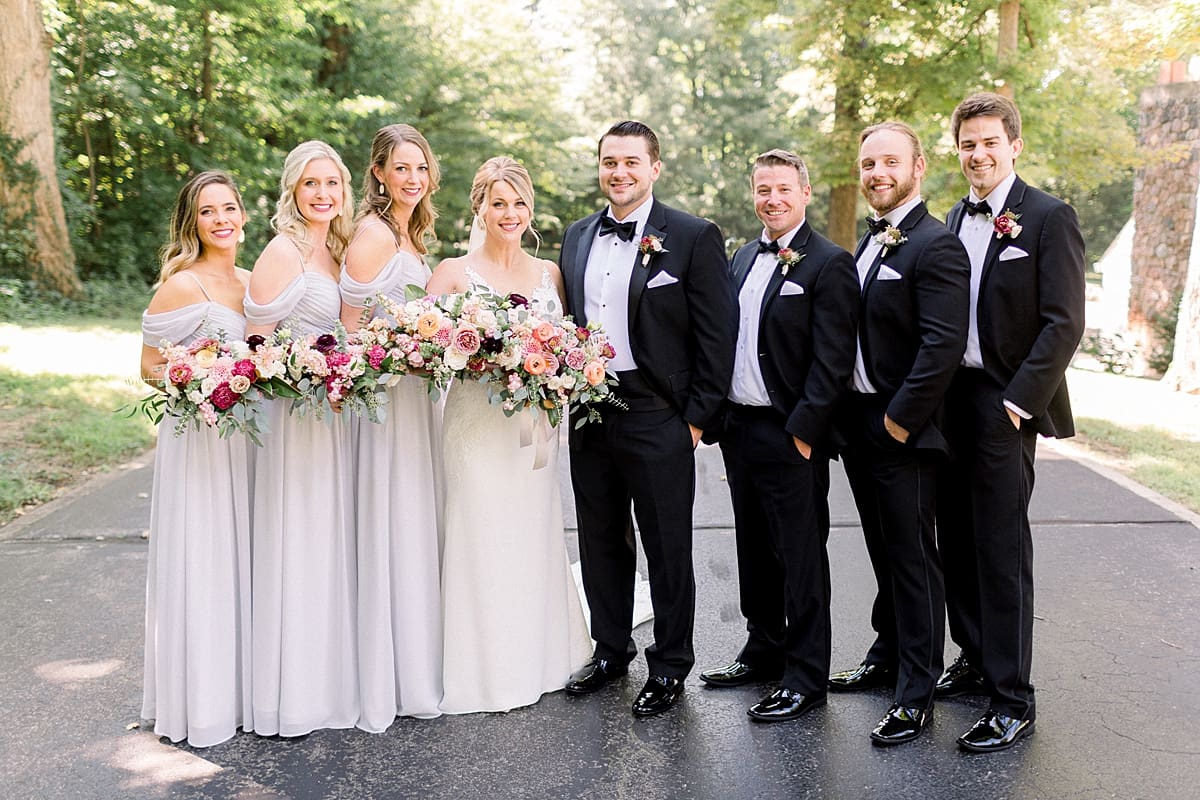 Arielle Peters Photography | Bride and groom smiling with wedding party at The Morris Estate in Niles, Michigan on wedding day. 