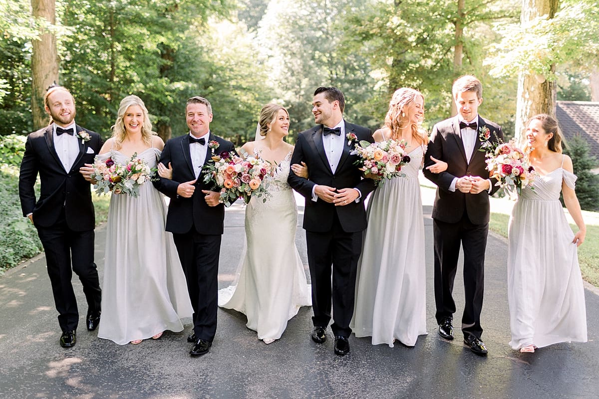 Arielle Peters Photography | Bride and groom and wedding party walking outside at The Morris Estate in Niles, Michigan on wedding day. 