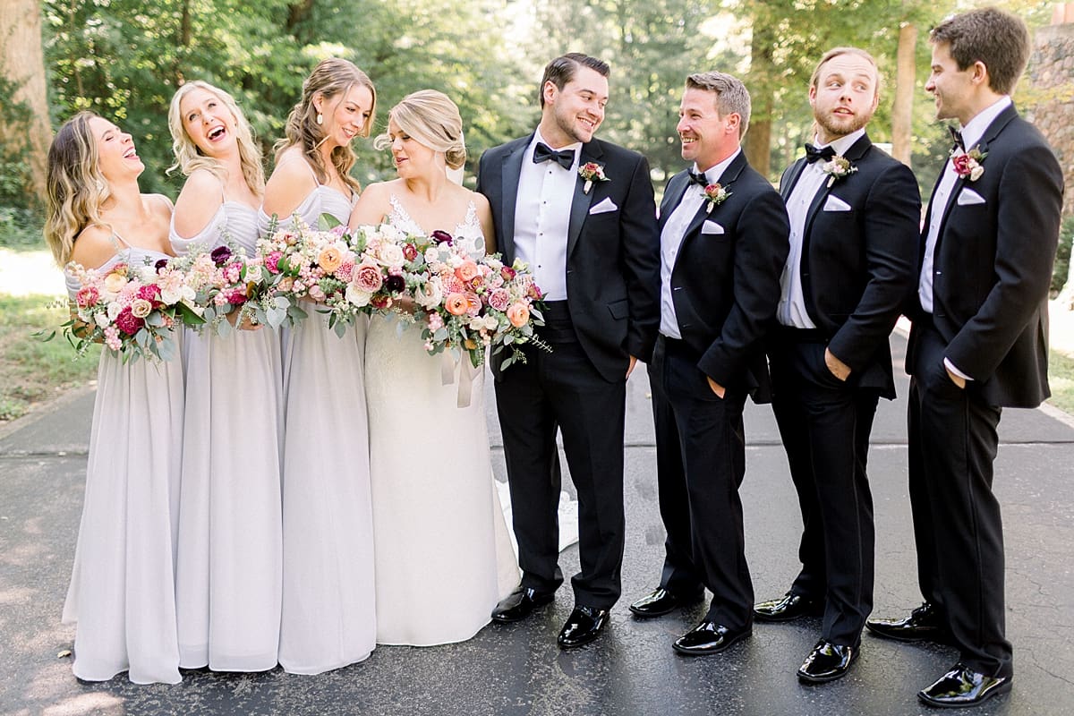 Arielle Peters Photography | Bride and groom laughing with wedding party outside at The Morris Estate in Niles, Michigan on wedding day. 