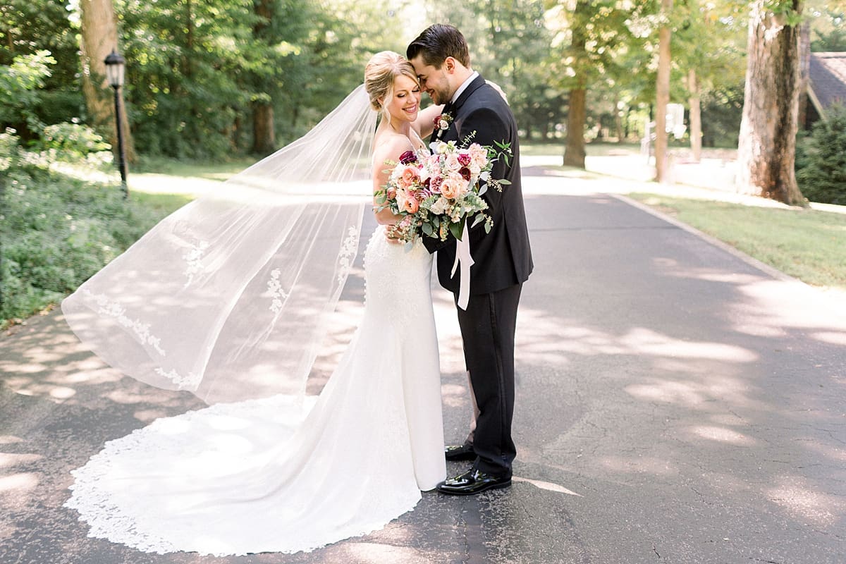 Arielle Peters Photography | Bride and groom smiling at each other outside at The Morris Estate in Niles, Michigan on wedding day. 