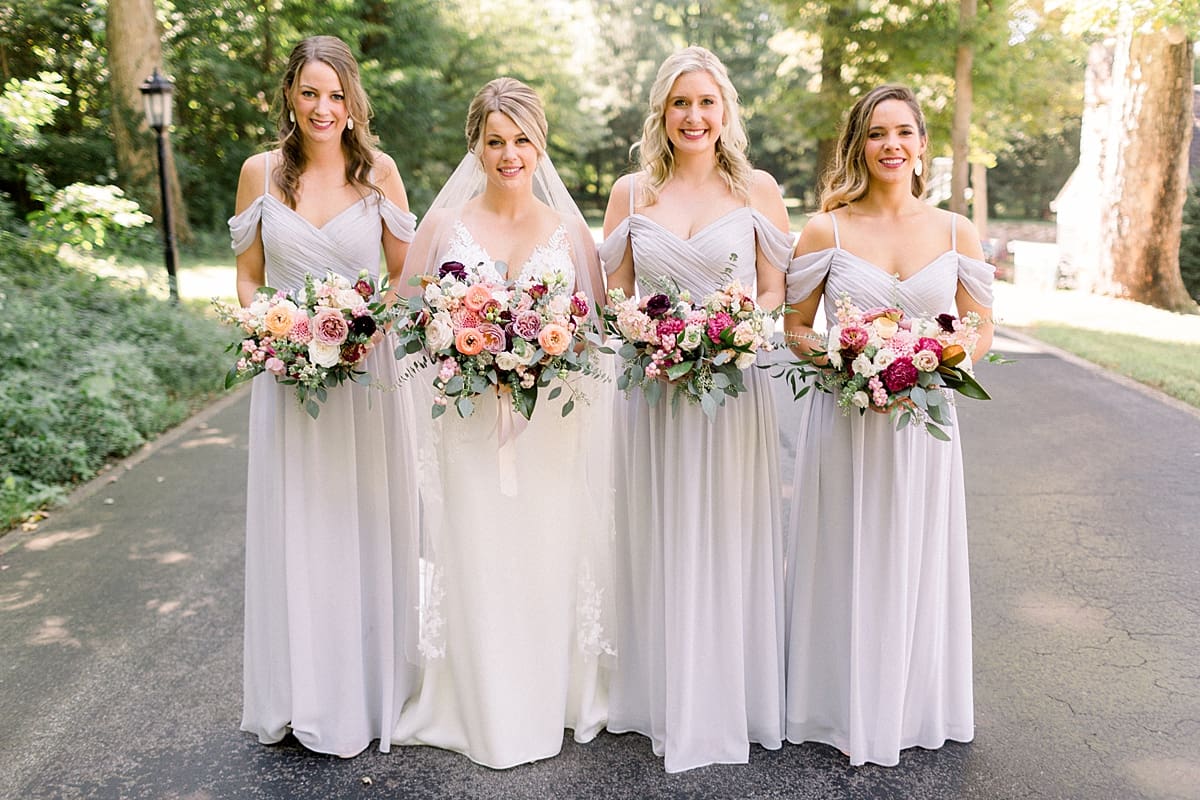 Arielle Peters Photography | Bride and bridesmaids holding their bouquets outside at The Morris Estate in Niles, Michigan on wedding day. 