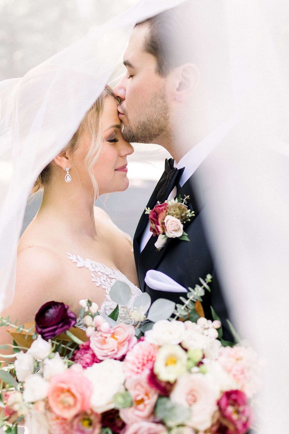 Arielle Peters Photography | Bride and groom kissing under her veil outside at The Morris Estate in Niles, Michigan on wedding day. 