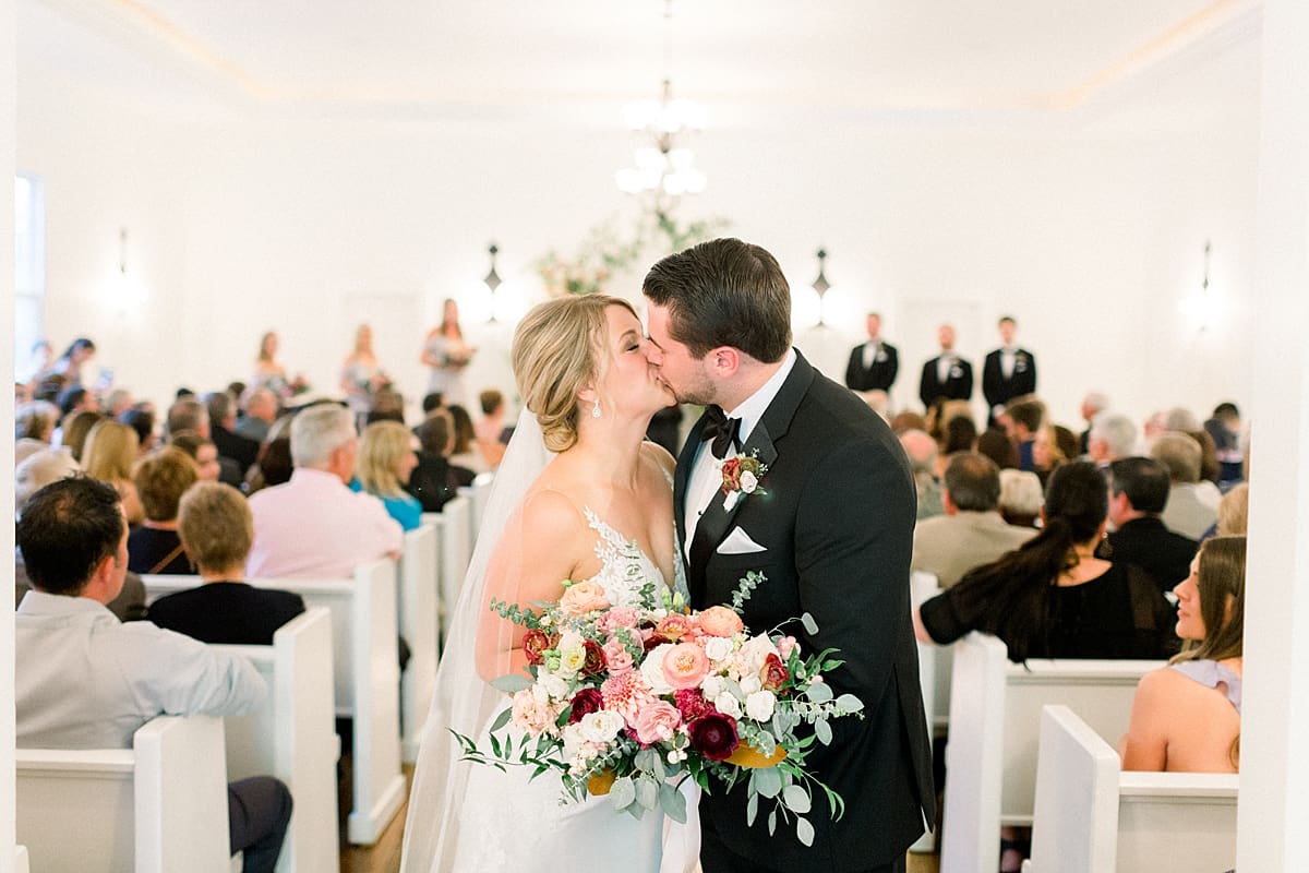 Arielle Peters Photography | Bride and groom kissing in the aisle at The Morris Estate in Niles, Michigan on wedding day. 