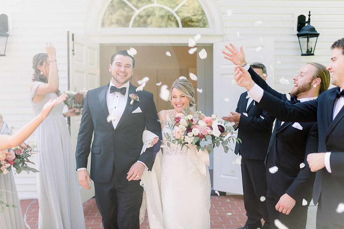 Arielle Peters Photography | Bride and groom walking out of the church throwing rose petals at The Morris Estate in Niles, Michigan on wedding day. 