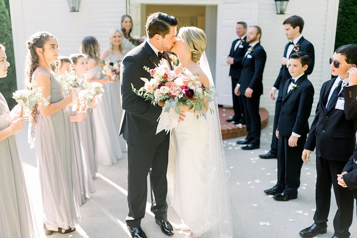 Arielle Peters Photography | Bride and groom kissing outside of the church at The Morris Estate in Niles, Michigan on wedding day. 