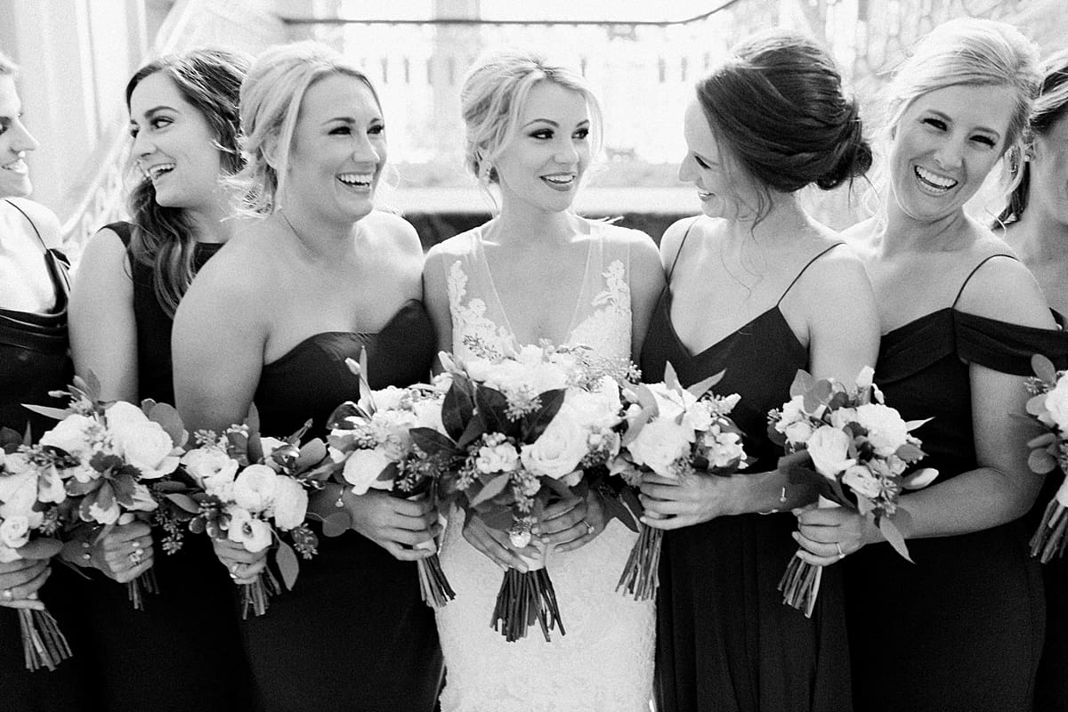 Arielle Peters Photography | Bride smiling with bridesmaids in Indianapolis on wedding day.