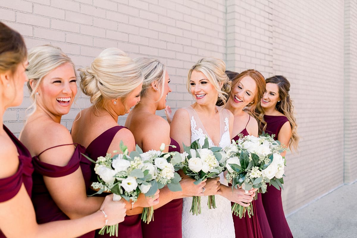 Arielle Peters Photography | Bride and bridesmaids laughing downtown Indianapolis on wedding day.