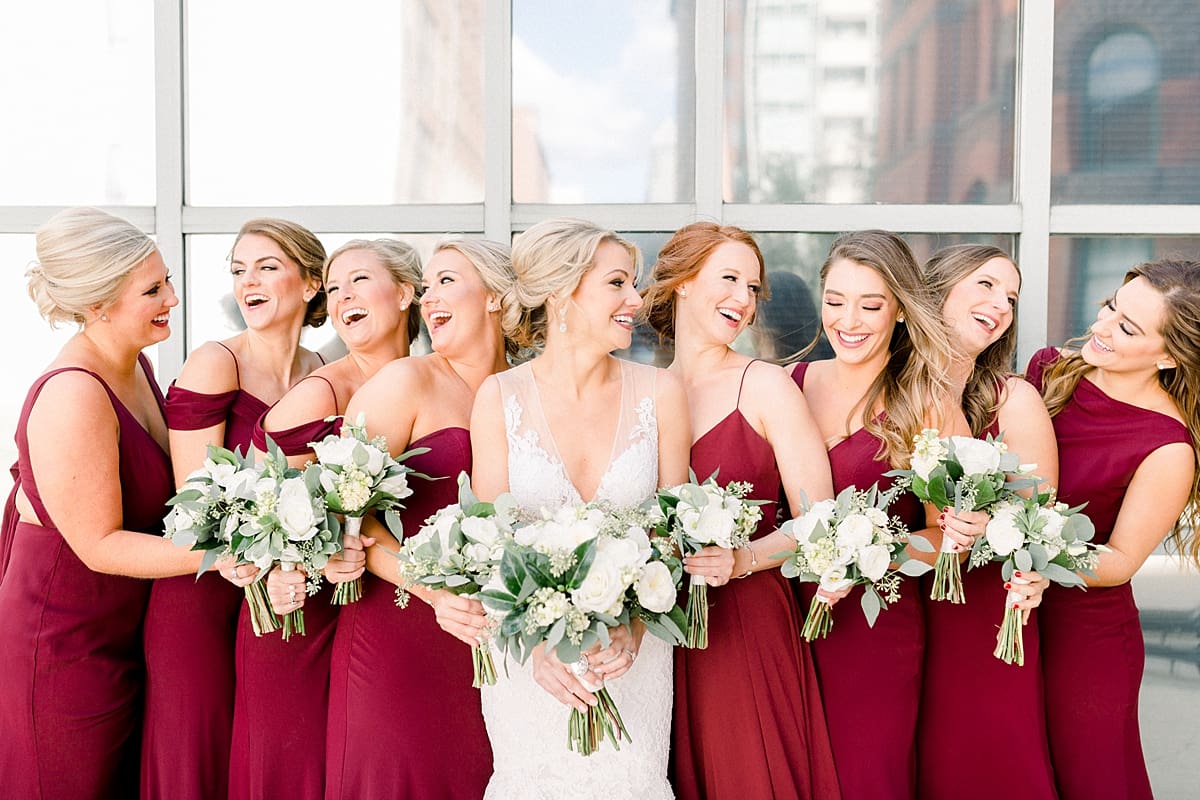 Arielle Peters Photography | Bride laughing with bridesmaids downtown Indianapolis on wedding day.