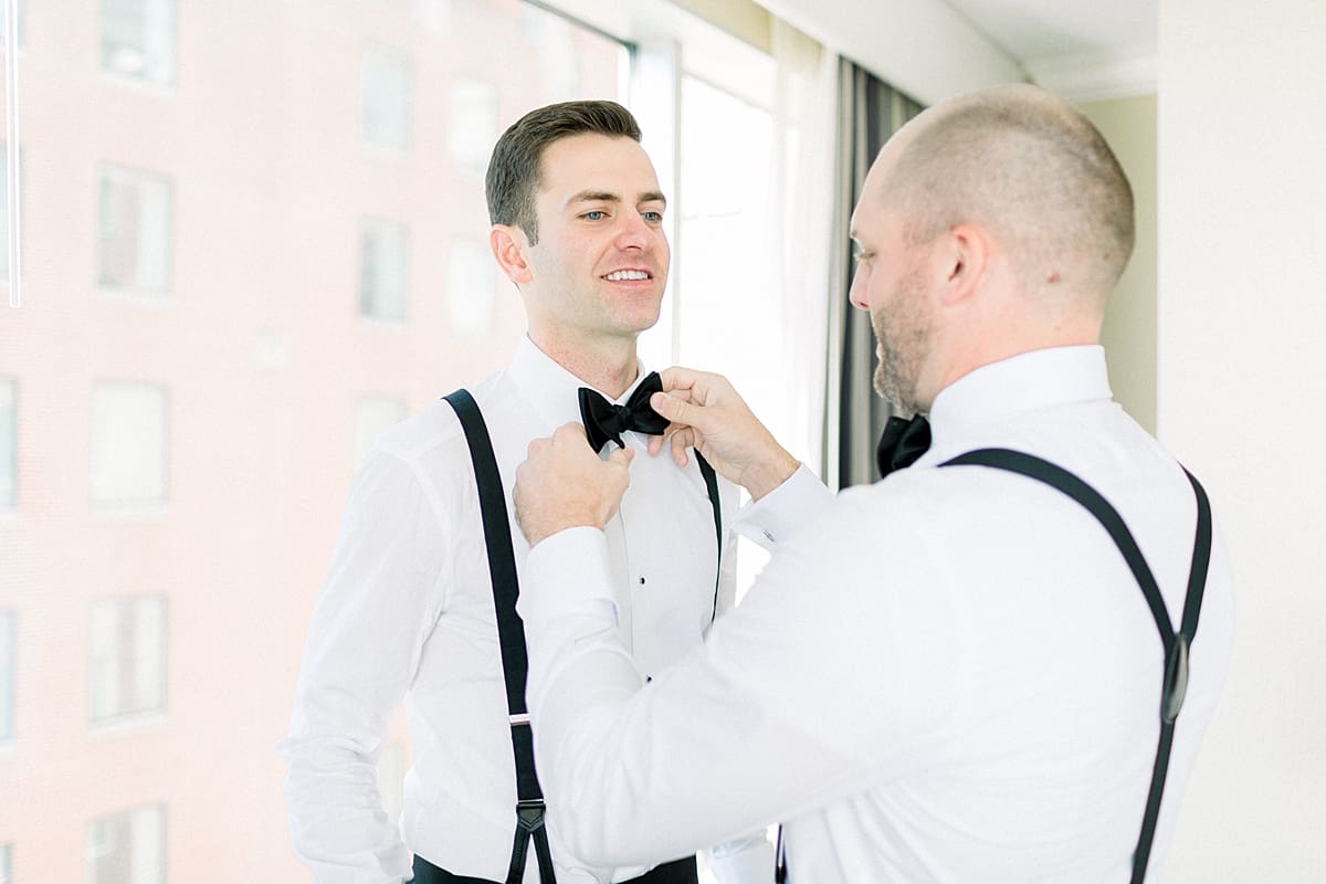Arielle Peters Photography | Groomsmen helping the groom with his bowtie in Indianapolis on wedding day.