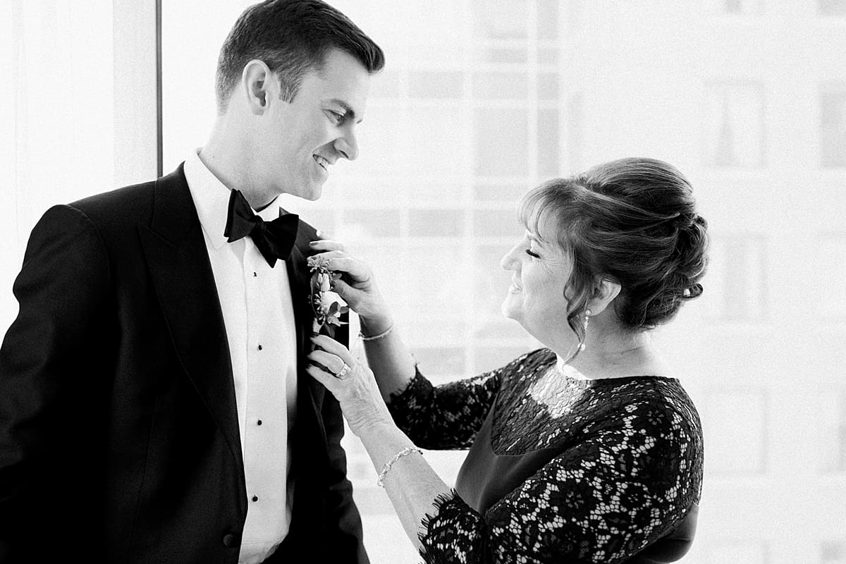 Arielle Peters Photography | Mother of the groom fastening his boutonnière in Indianapolis on wedding day. 
