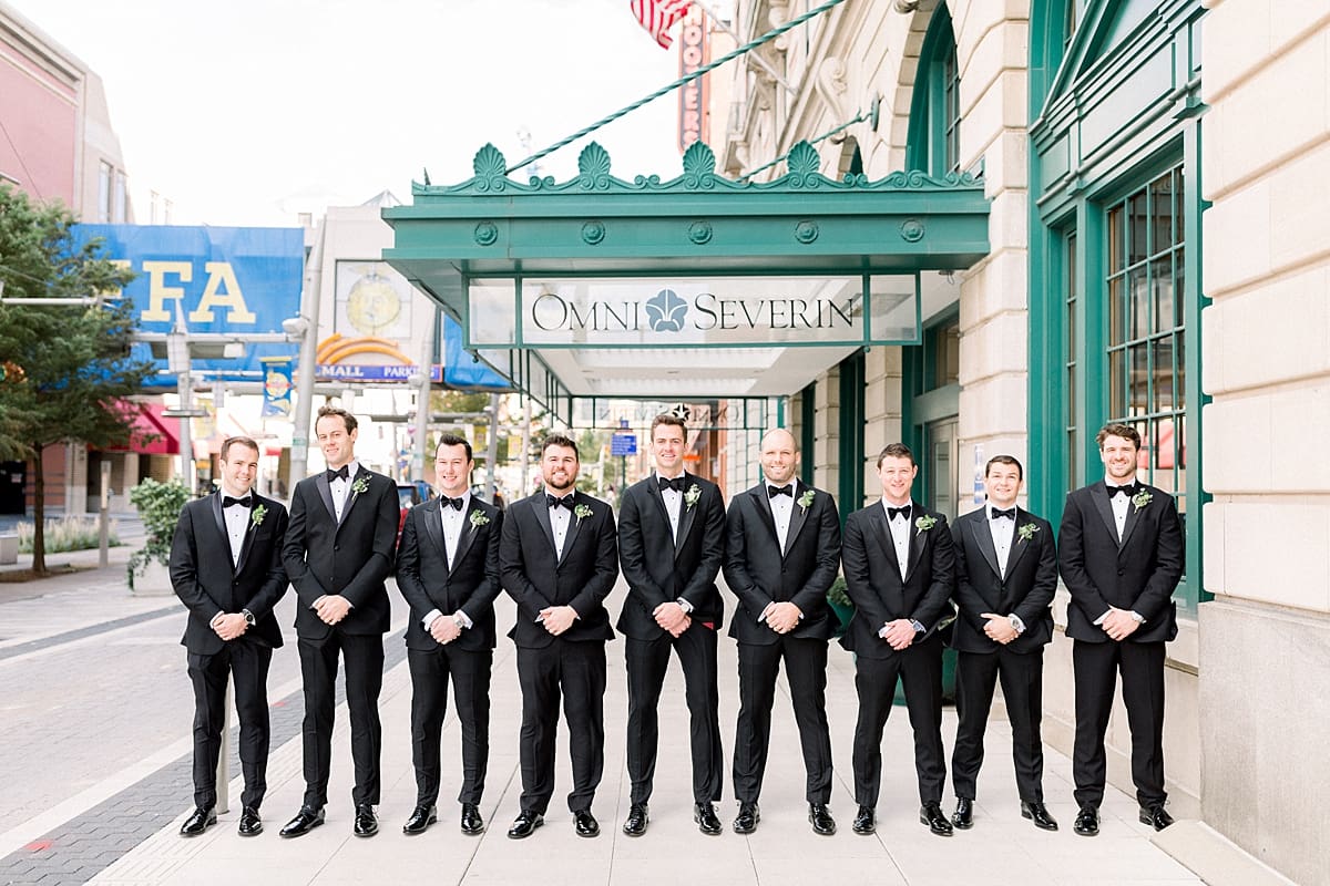 Arielle Peters Photography | Groom and groomsmen lined up in their tuxes downtown Indianapolis on wedding day.