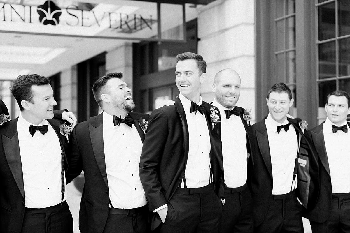 Arielle Peters Photography | Groom and groomsmen laughing downtown Indianapolis on wedding day.