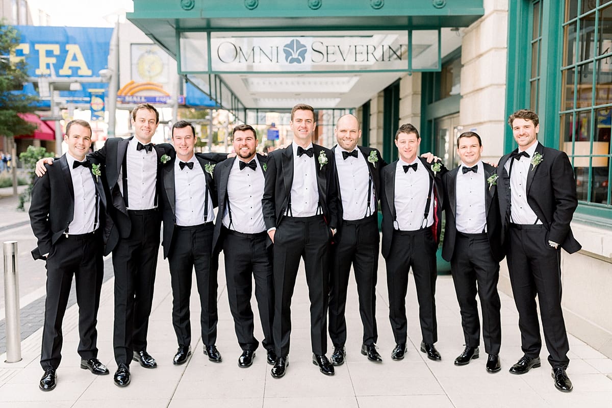 Arielle Peters Photography | Groom and groomsmen lined up and smiling downtown Indianapolis on wedding day.