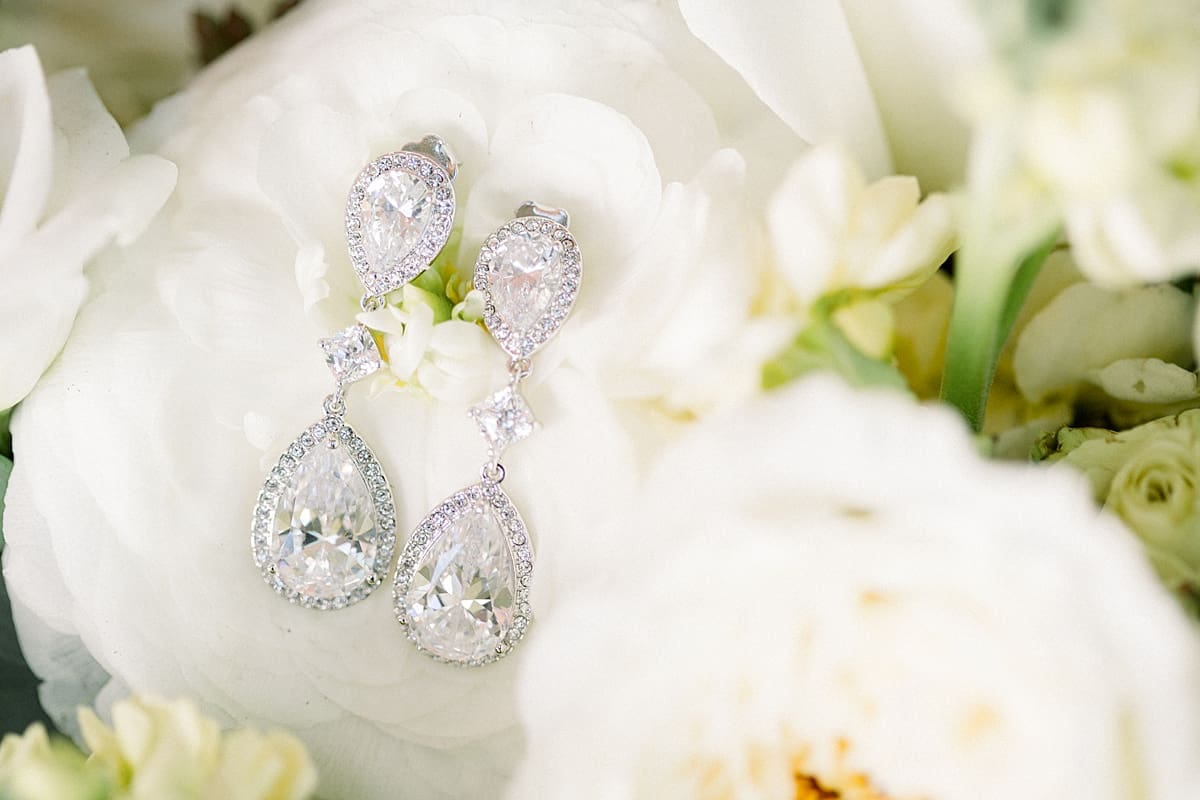 Arielle Peters Photography | Bride's diamond wedding earrings on roses on wedding day in Indianapolis.