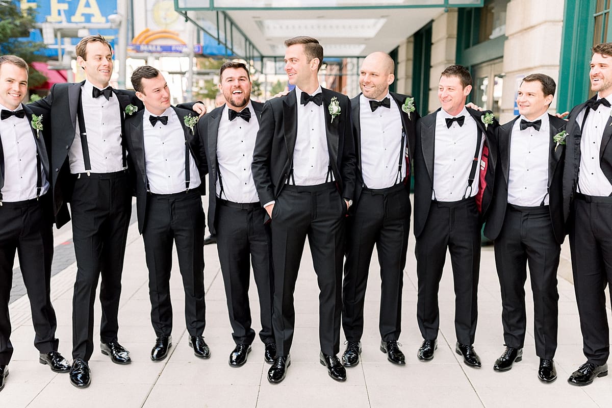 Arielle Peters Photography | Groom and groomsmen lined up and laughing downtown Indianapolis on wedding day.