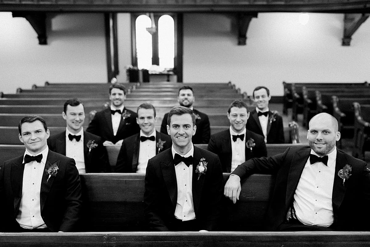 Arielle Peters Photography | Groom and groomsmen sitting and smiling inside Roberts Park Church in Indianapolis.