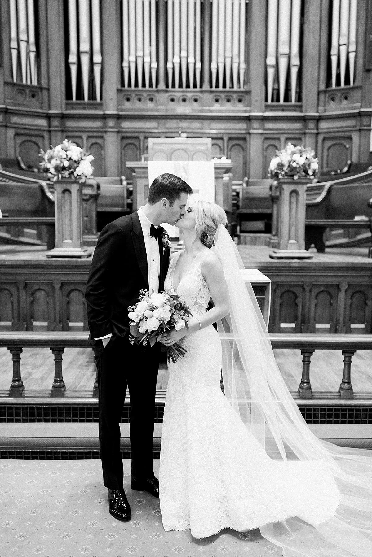 Arielle Peters Photography | Bride and groom kissing inside Roberts Park Church in Indianapolis on wedding day.
