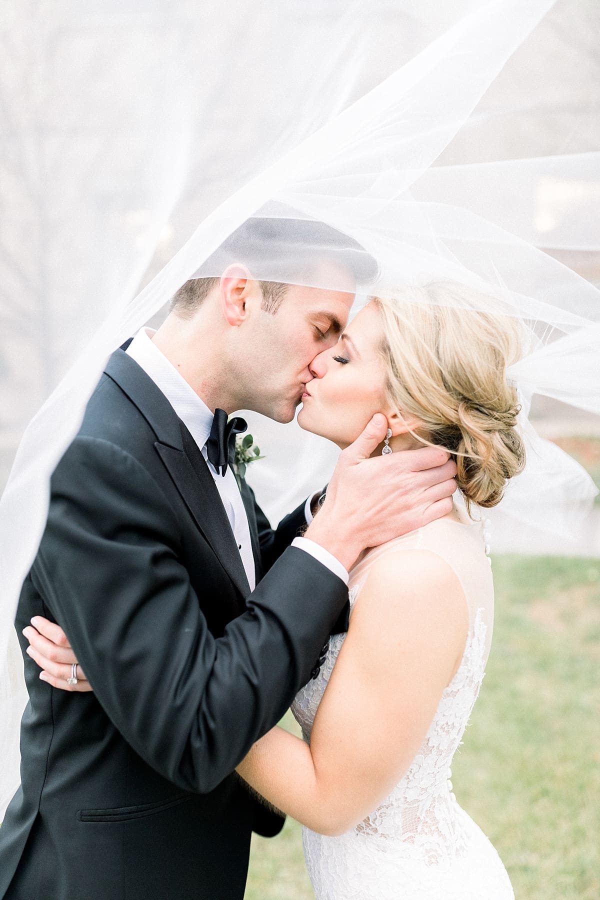 Arielle Peters Photography | Bride and groom kissing under flowing veil downtown Indianapolis on wedding day.